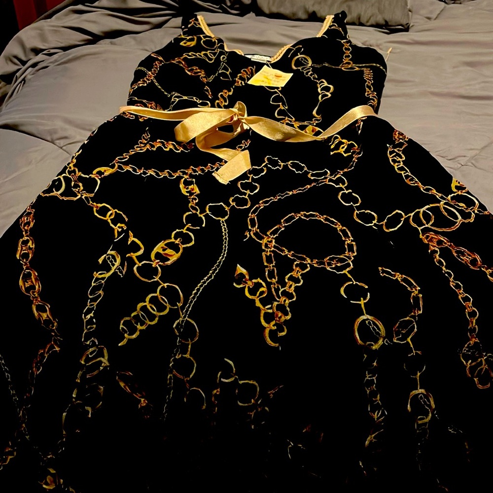 Black sheer dress with gold chain design size large. NWT